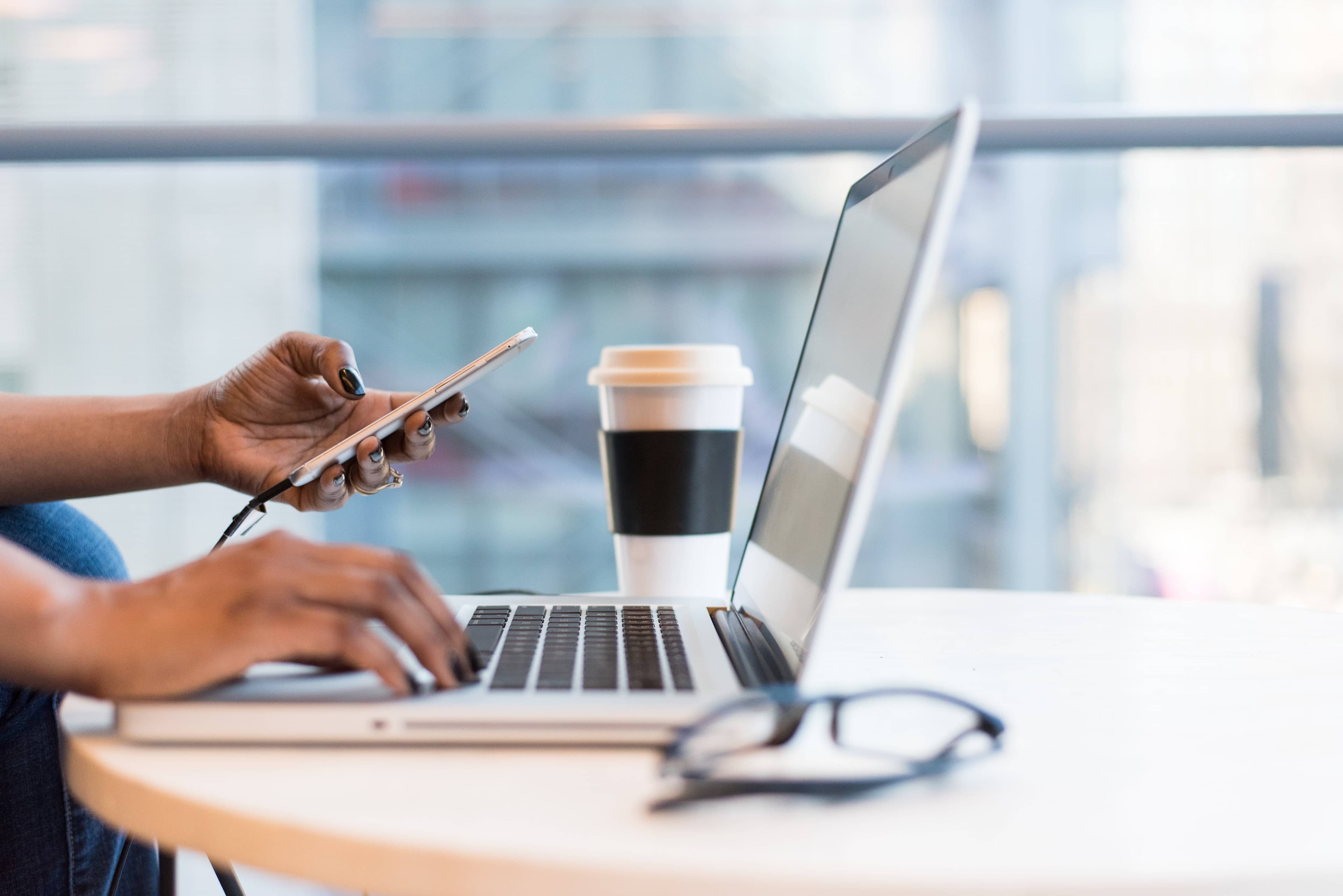 a person using a laptop and phone